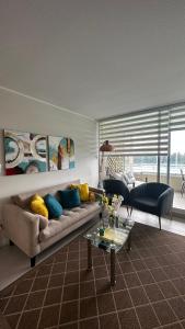 a living room with a couch and a table at Departamento Playa Las Cruces LagunaMar 3D2B con KYAK in Las Cruces +41 photos