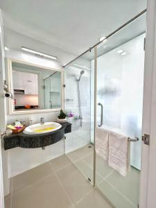 a bathroom with a glass shower and a sink at Ocean Vista in Mui Ne
