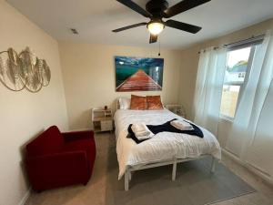 a bedroom with a bed and a red chair at Modern Wi-Fi, Pet friendly home for Families in Greenville