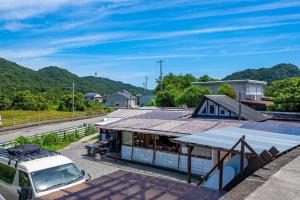 a building with a van parked in front of it at Haryugetu Guesthouse in NASA in Kaiyo
