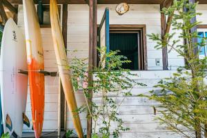 a group of surfboards leaned up against a house at Haryugetu Guesthouse in NASA in Kaiyo