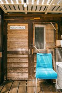 a blue chair sitting on the porch of a building at Haryugetu Guesthouse in NASA in Kaiyo