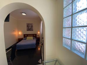sypialnia z łóżkiem i oknem w obiekcie AH Teatinos w mieście Santiago