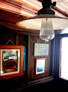 a light hanging from a ceiling with a picture and a window at Haryugetu Guesthouse in NASA in Kaiyo