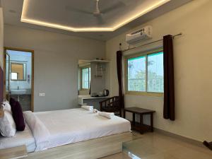 a bedroom with two beds and a window at Max Guest House in Agra