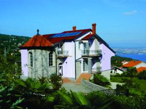 a large white house with a red roof at Villa Laurea in Lovran