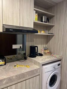 a kitchen with a washing machine on a counter at Xing Fave NagoyaThamrin City in Jodoh
