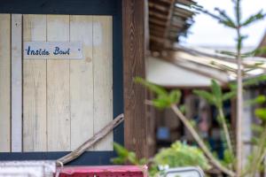a wooden wall with a sign that reads inside box at Haryugetu Guesthouse in NASA in Kaiyo
