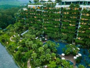 - une vue aérienne sur un complexe avec des arbres et une rivière dans l'établissement Flamingo Dai Lai Resort - Hotel & Villas- by Bay Luxury, à Phúc Yên