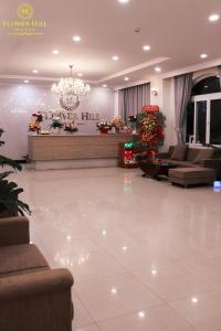 a lobby with couches and a chandelier at Flower Hill in Da Lat