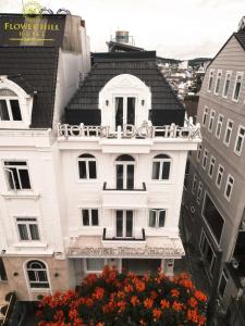 a white building with flowers in front of it at Flower Hill in Da Lat