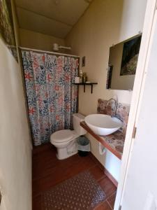 a bathroom with a toilet and a sink at Hostal Las Veraneras Ataco in Concepción de Ataco