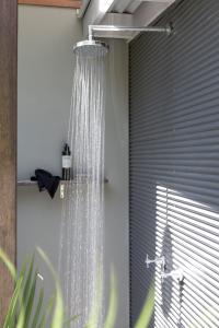a shower in a bathroom next to a window at Lily Pad at Byron Bay in Byron Bay