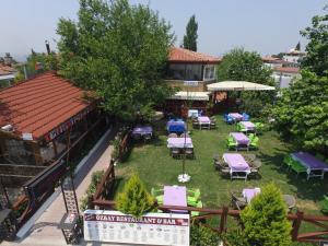 an aerial view of a building with chairs and umbrellas at Ozbay Hotel in Pamukkale