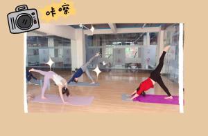 a group of people doing yoga in a room at Olioinn B&B in Wenchang