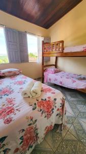two beds in a room with two bunk beds at Hospedagem Casa Da Lia in Lençóis