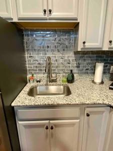 a kitchen with a sink and a counter top at Downtown Albany 2 Bedroom + Workstation @ The Mark in Albany