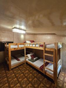 a room with three bunk beds in it at The Gather Inn Room Rentals - Baguio City in Baguio