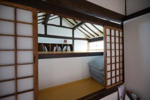 a room with a bunk bed and a window at Bonghwangjae Hanok Guesthouse in Gongju