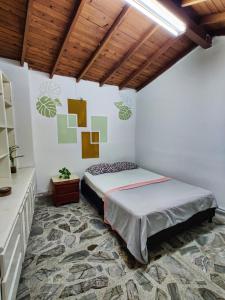 a bedroom with a bed and a wooden ceiling at Lady Mom Hostal in Medellín