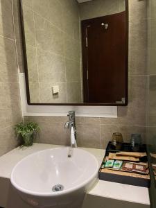 a bathroom with a white sink and a mirror at Homestay Bắc Ninh in Bắc Ninh