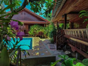 a backyard with a pool and a bench and a house at My dream house resort in Jomtien Beach