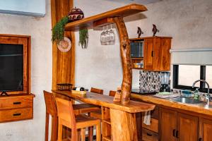 a kitchen with a wooden counter top in a room at Ria Aayin Apartments in Río Lagartos