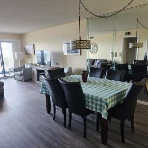 a dining room with a table and chairs at Sandcastles Condominium Complex in Cocoa Beach