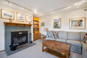 a living room with a couch and a fireplace at Incredible Highridge 2 bedroom 2 bathroom with Indoor Pool A14 in Killington