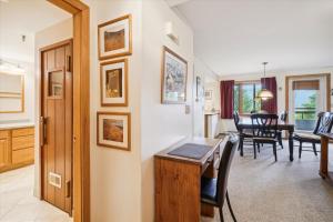 a living room with a desk and a dining room at Incredible Highridge 2 bedroom 2 bathroom with Indoor Pool A14 in Killington +28 photos