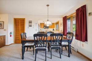 a dining room with a table and chairs at Incredible Highridge 2 bedroom 2 bathroom with Indoor Pool A14 in Killington