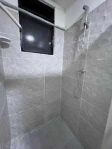 a bathroom with a shower with a window at Habitacion Donde Anita in Florencia