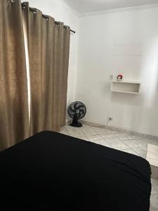 a bedroom with a shower curtain in a room at Casa Al Mare in Itanhaém