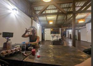 a woman standing at a table in a kitchen at WaterMellow Hostel in Koh Tao