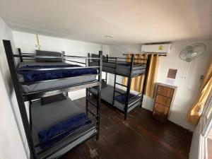 a room with three bunk beds in a room at WaterMellow Hostel in Koh Tao