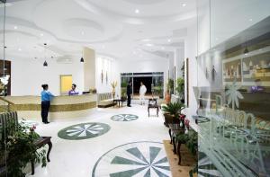 a lobby with people standing in a building at Palm Djerba Suites in Mezraya +37 photos