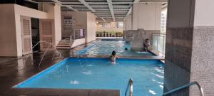 two people in a swimming pool in a building at ADB TOWER ADB AVENUE in Manila