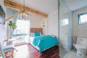 a bathroom with a bed and a glass shower at Lacasa May in Da Lat +94 photos