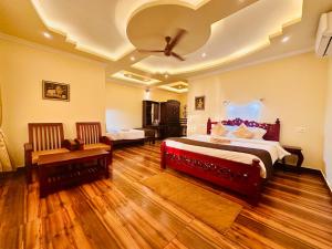 a bedroom with a large bed with a red headboard at Maadathil Beach Resort in Varkala