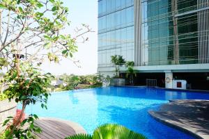 a large swimming pool in front of a building at The Cabin Mataram City in Kejayan
