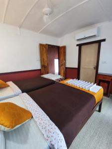 a bedroom with two beds with white chairs on them at Kalappura Houseboats & Tours in Alleppey