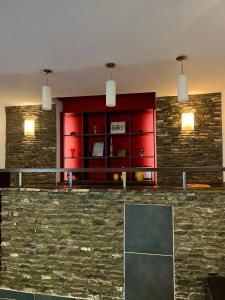 a ping pong table in a room with a red wall at Pensiunea Rodis in Moieciu de Sus