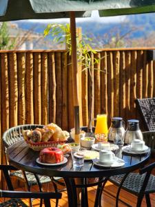 a table with food on it on a patio at Chalés Araucária e Manacá in São Bento do Sapucaí