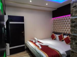 Postel nebo postele na pokoji v ubytování Hotel Swagat