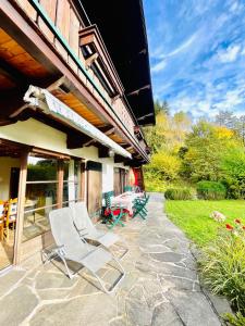 a couple of lawn chairs sitting on a patio at Gäste Residenz Happy Kitz in Kitzbühel