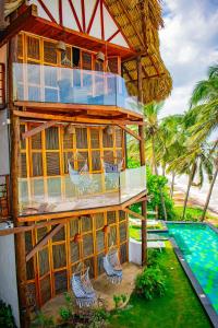 a house with a balcony and a swimming pool at RCH LUXURY HOTEL & POOL in Dibulla