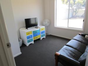 a living room with a tv and a couch at Shackleton in Point Turton