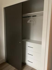 a closet with white drawers and a black wall at Modern and cozy 4-Plex with a view! (1Bed, 1 Private Bathroom) in Kelowna