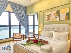 a bedroom with a bed with a flower arrangement on it at Country Garden Danga Bay InStyle Sea View Homestay Suite by NEO in Johor Bahru