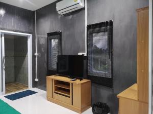 a living room with a television on a table at Baan Sabaijai Viking Home in That Phanom